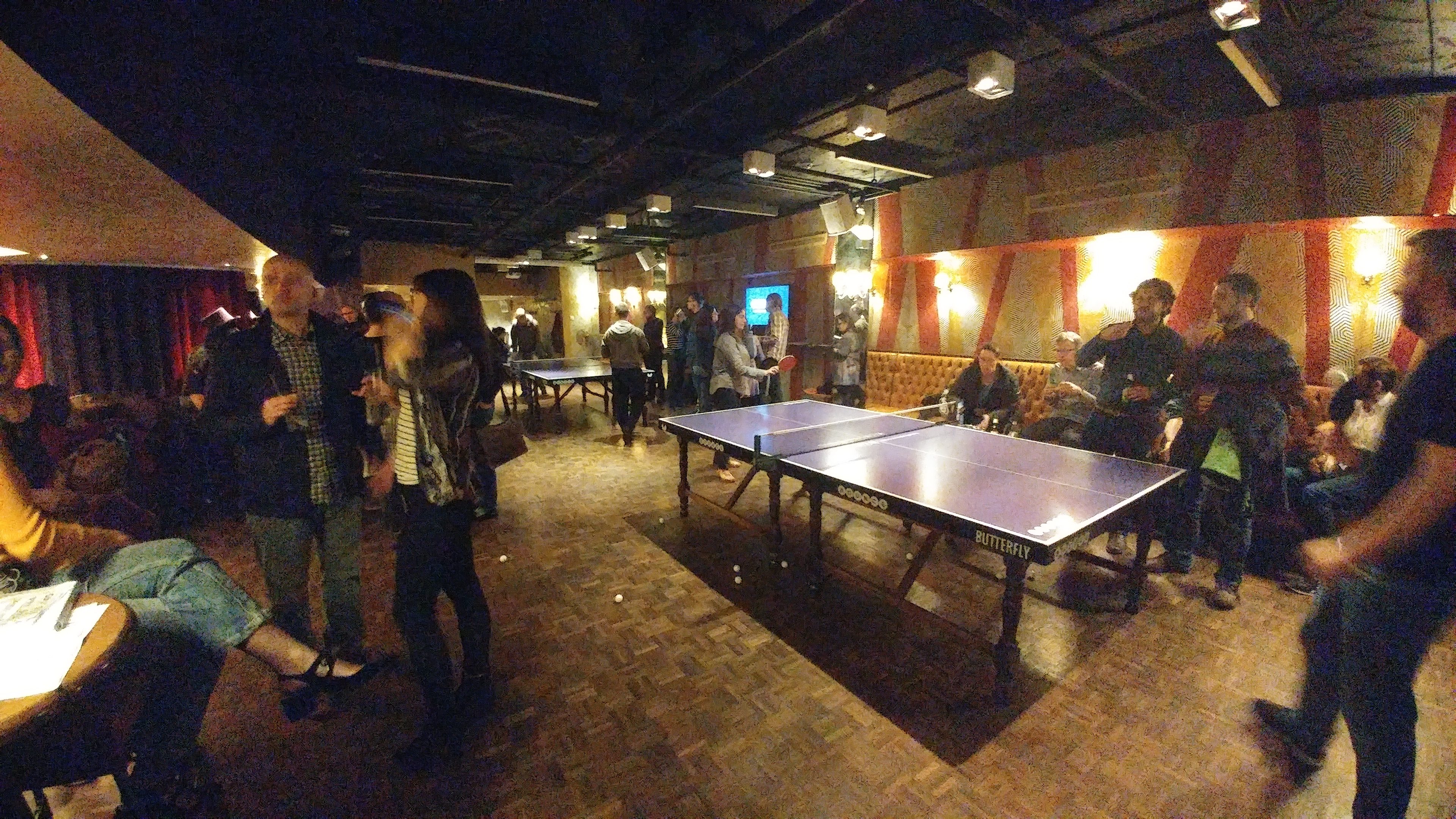 Volunteer, speaker and organiser event with people playing ping pong.