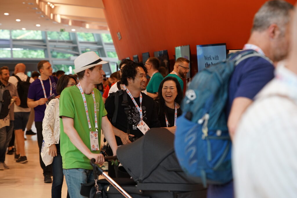 Me pushing the bassinet stroller through a crowd of attendees